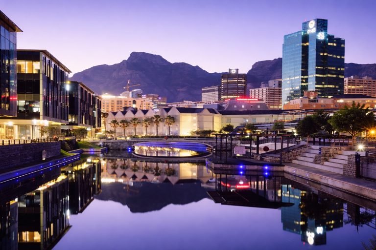Twilight view of Cape Town city center and canal reflections with Table Mountain in the background