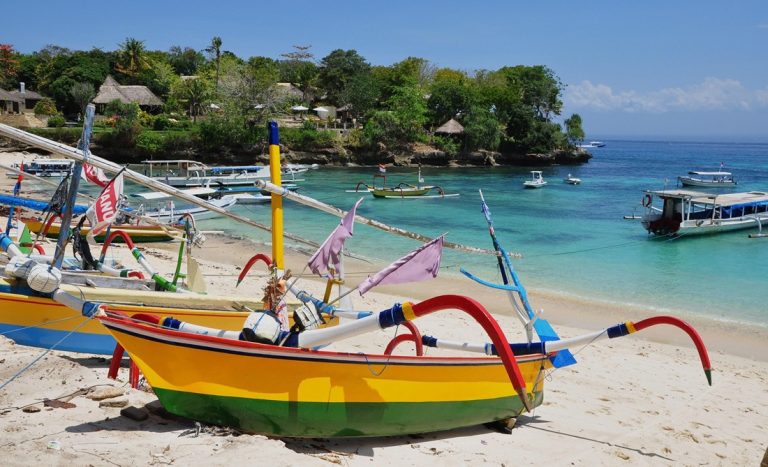 Colorful traditional fishing boats on a tropical beach in Bali - things to do in Bali Caption: Description: