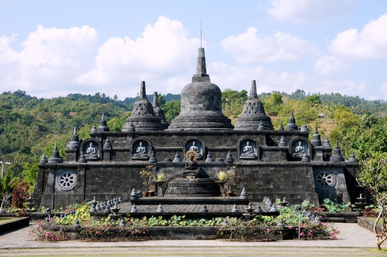 Traditional stone temple surrounded by tropical landscape in Bali - things to do in Bali Caption: Description: