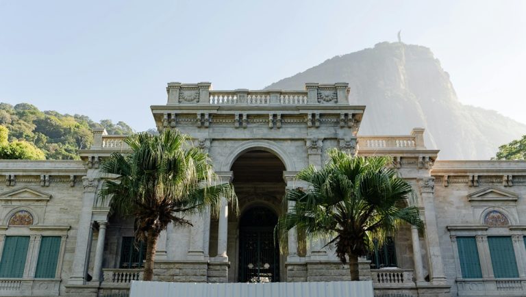 Historic building with Sugarloaf Mountain in the background featured in this things to do in Rio de Janeiro guide Caption: Description: