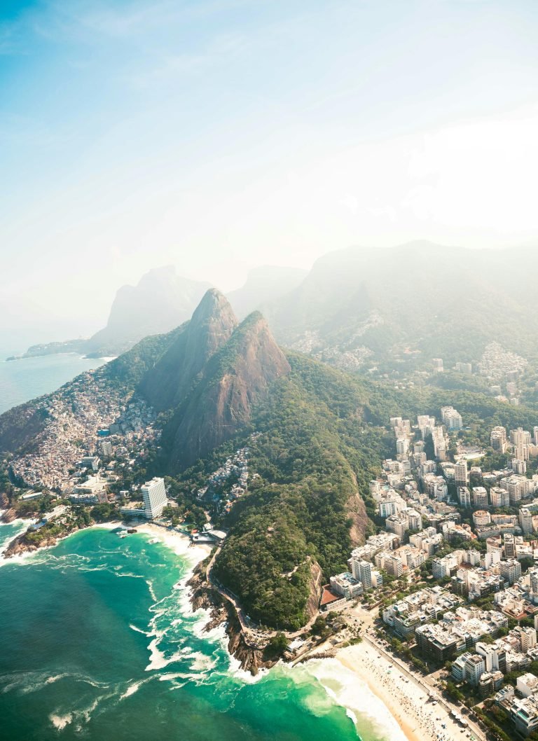 Things to do in Rio de Janeiro: Aerial view of Rio de Janeiro coastline showing beaches, neighborhoods, and mountains