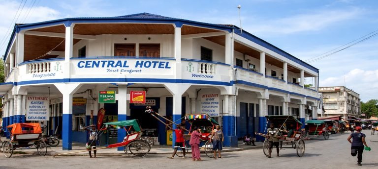 Central Hotel in Tulear, Madagascar, a colonial-style landmark in the city center surrounded by pousse-pousse rickshaws and daily street life