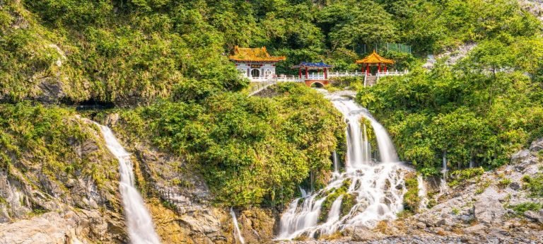 Eternal Spring Shrine and waterfalls cascading down lush cliffs in Taroko Gorge, Taiwan