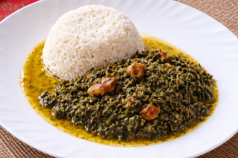Ravitoto, a traditional Malagasy dish of finely crushed cassava leaves slow-cooked with pork and served with white rice