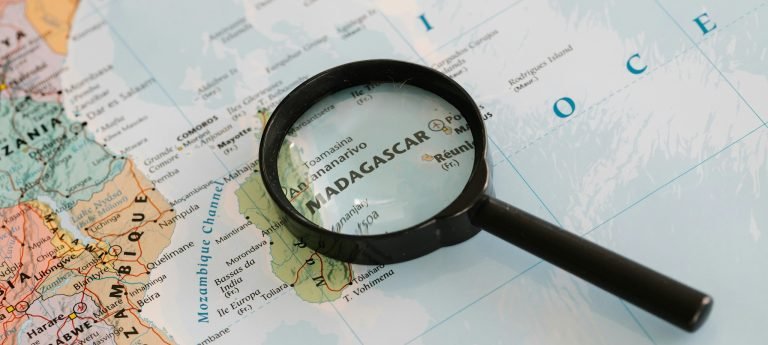 Map of Madagascar highlighted with a magnifying glass, showing the island’s location in the Indian Ocean off the coast of Africa