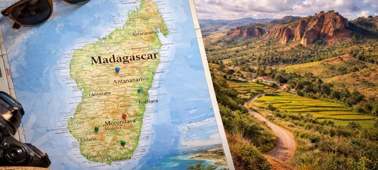 Map of Madagascar overlaid on a red highlands landscape, illustrating the island’s geography and unique terrain for trip planning