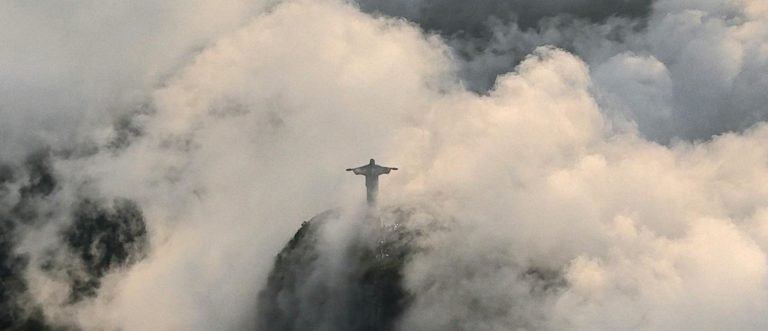 Christ the Redeemer emerging through clouds on Corcovado Mountain in Rio de Janeiro