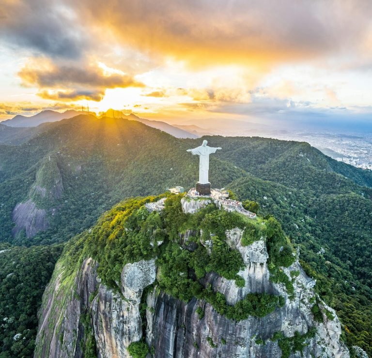 Christ the Redeemer statue on Corcovado Mountain at sunrise overlooking Rio de Janeiro