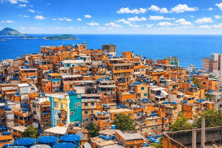 Colorful favela in Rio de Janeiro on a bright sunny afternoon with blue skies and ocean in the background