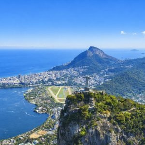Brazil Itinerary: Christ the Redeemer overlooking Rio de Janeiro on a bright sunny afternoon with blue skies and Guanabara Bay in the background