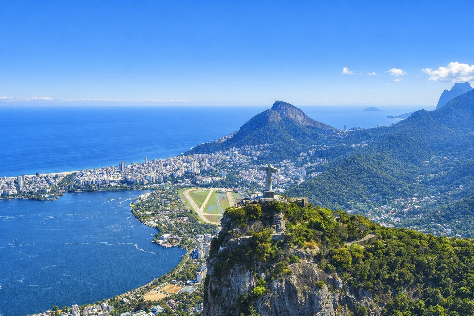 Brazil Itinerary: Christ the Redeemer overlooking Rio de Janeiro on a bright sunny afternoon with blue skies and Guanabara Bay in the background