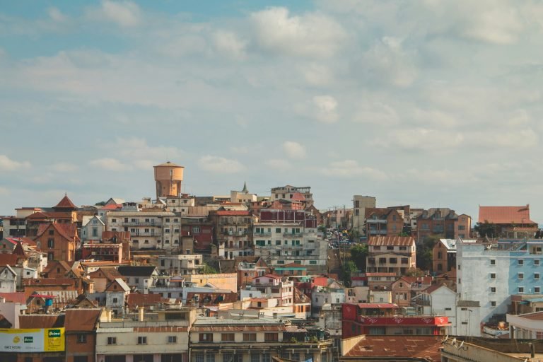 Panoramic view of Antananarivo Madagascar with hillside houses and historic buildings under a warm afternoon sky Caption Description