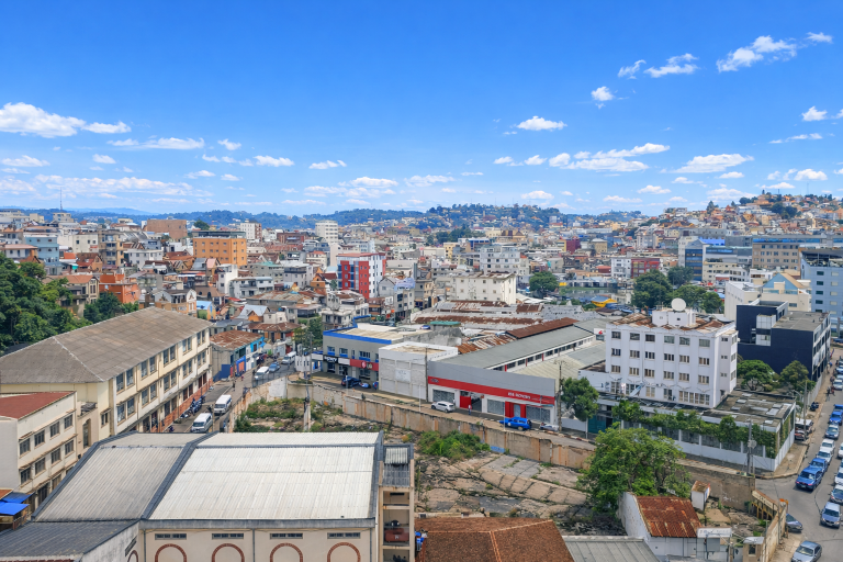 Panoramic city view of Antananarivo Madagascar with colorful buildings and hills under bright blue skies Caption Description