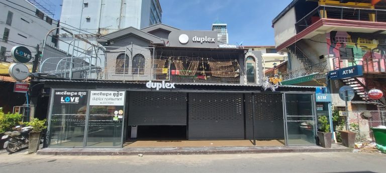 Things to do in Cambodia: Duplex Belgian Tavern restaurant in Phnom Penh street with outdoor seating and modern facade and the famous Love Club upstairs