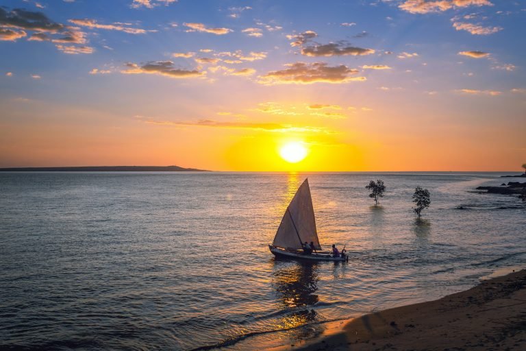 Traditional sailboat at sunset on the coast of Madagascar Caption Description
