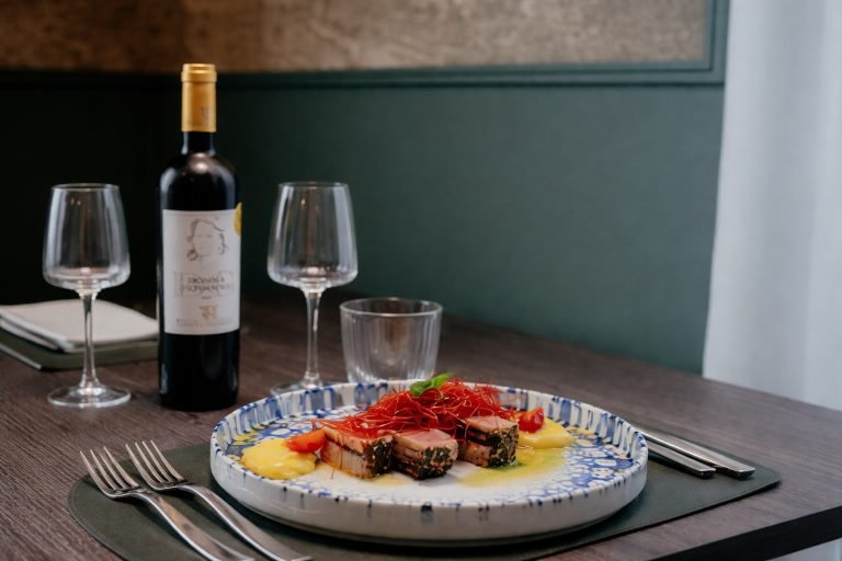 Sydney Tours Experiences - Food and wine dining scene with plated dish and wine in a restaurant setting