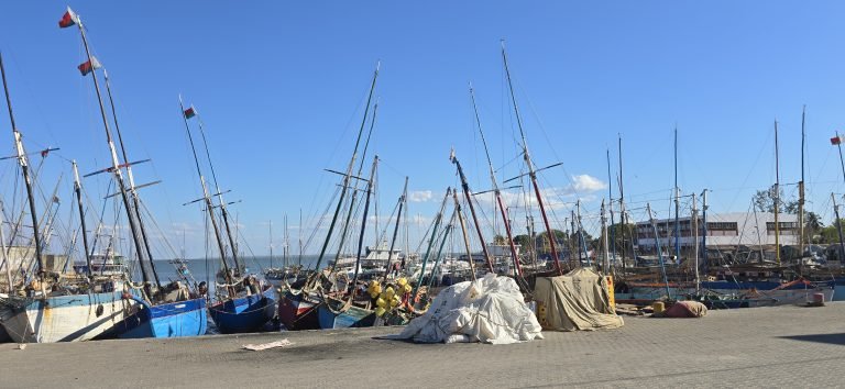Fishing boats in the harbour of Mahajanga Madagascar with colorful wooden vessels and blue skies