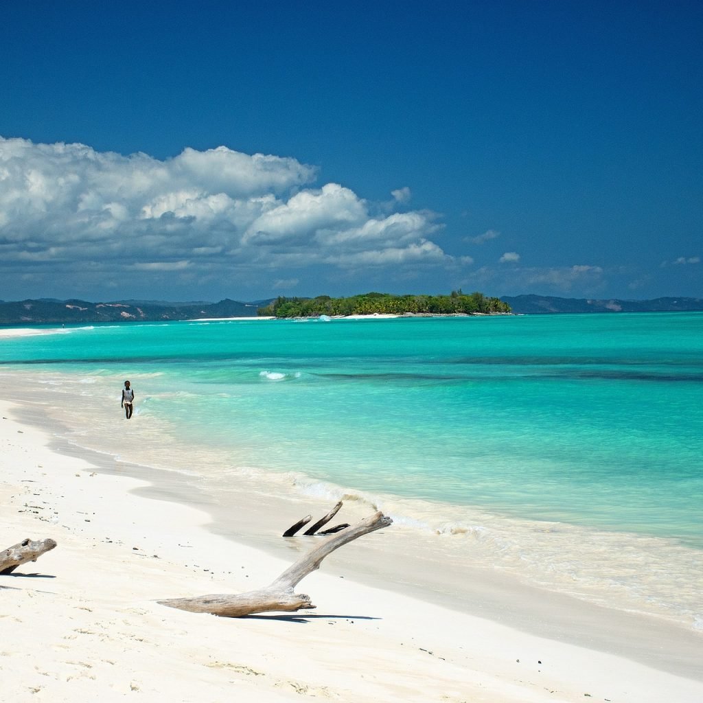 Madagascar packing list for beach travel with white sand beach and turquoise water in Nosy Be