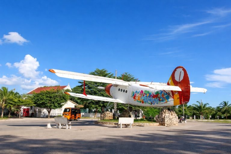 Bright sunny day in Majunga Madagascar with blue skies and historic airplane monument in the city square
