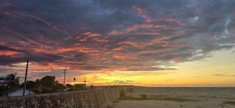 Colorful sunset over the coast of Madagascar with dramatic clouds and ocean view