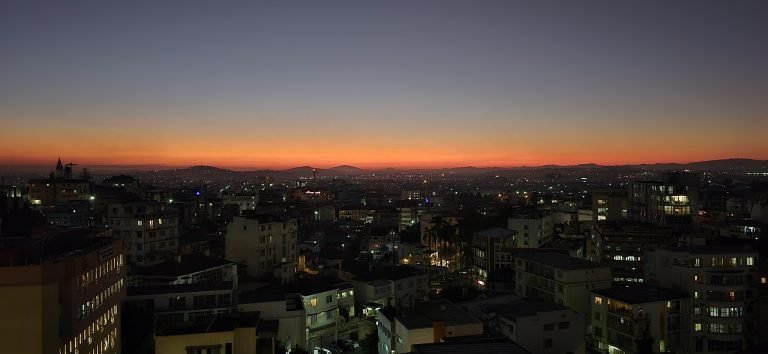 Sunset skyline of Antananarivo Madagascar with city lights and hills on the horizon