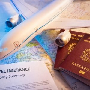 Is Travel Insurance Worth It - Travel insurance policy document with airplane model, passports and world map representing international travel protection