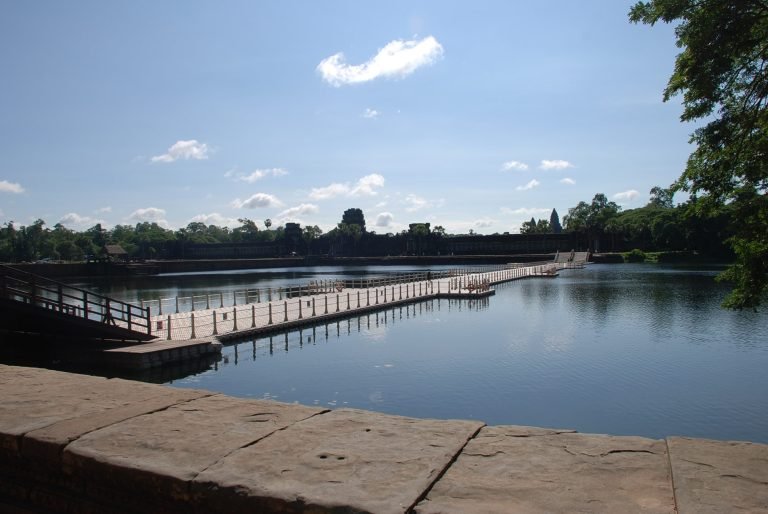 Angkor Wat Guide showing the floating bridge across the moat leading to the temple entrance in Siem Reap Cambodia