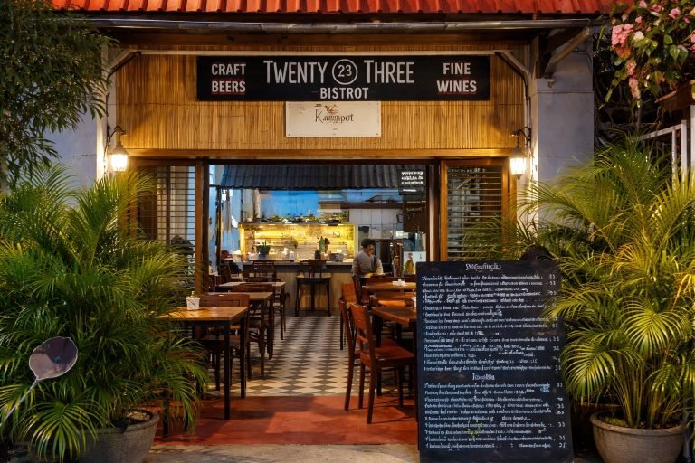 things to do in Kampot Twenty Three Bistro restaurant exterior with outdoor seating and warm lighting Caption Description