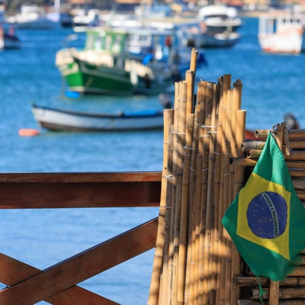 Brazil travel cost coastal harbor view with boats and Brazilian flag