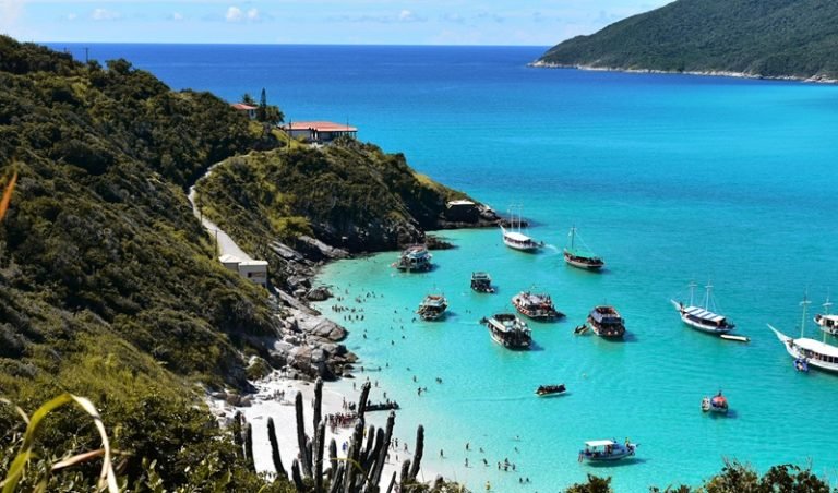 Brazil travel tips: turquoise beach with boats and coastal cliffs showing popular beach destinations in Brazil