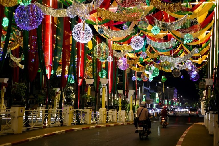Things to do in Siem Reap include exploring beautifully decorated bridges at night with colorful lanterns and festive lights Caption Description