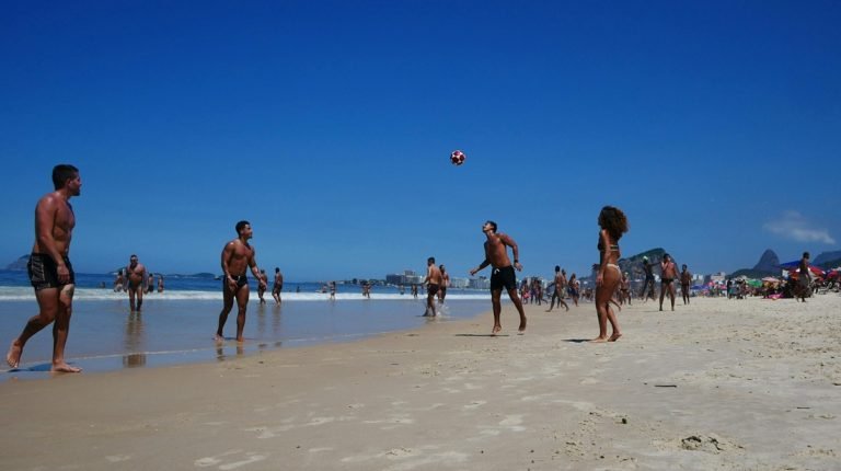 Brazil travel tips: locals playing football on Copacabana beach in Rio de Janeiro