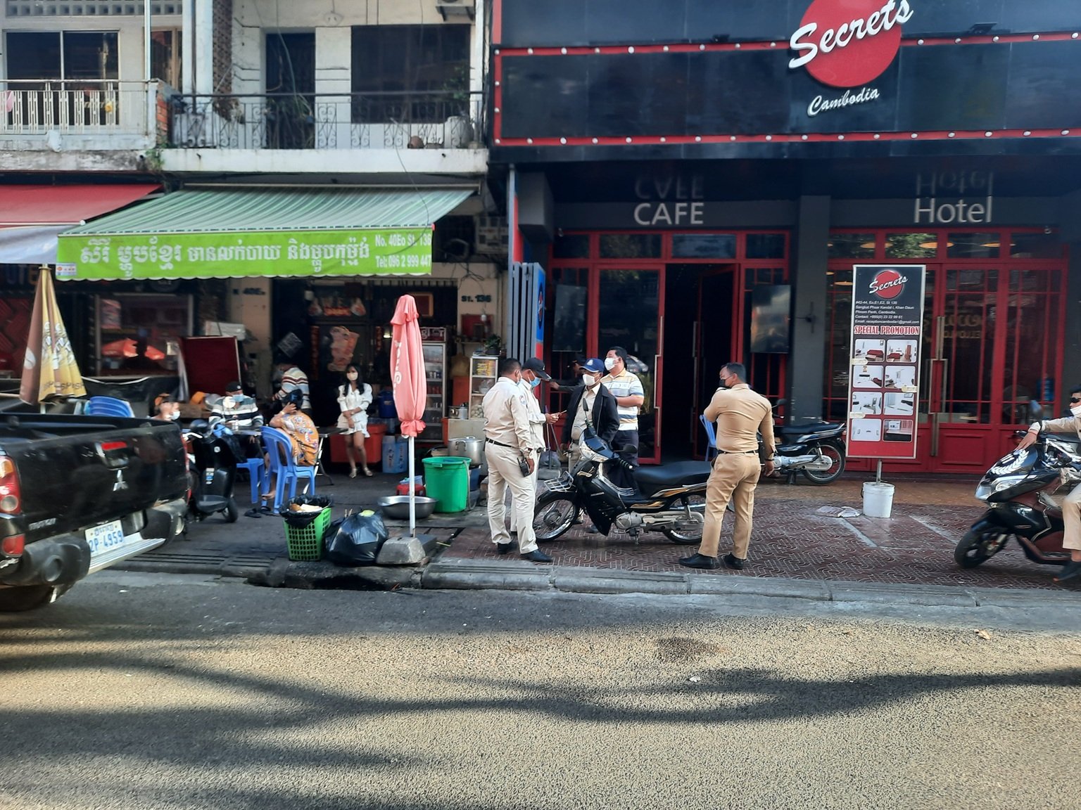 Is cambodia safe - street scene in Phnom Penh with local police and traffic on busy road