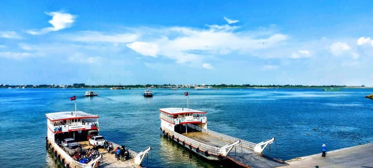 ferry crossing on the mekong river in phnom penh cambodia with vehicles and local transport