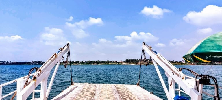 Phnom Penh itinerary Tonle Sap ferry bow view over water with open river ahead Caption Description