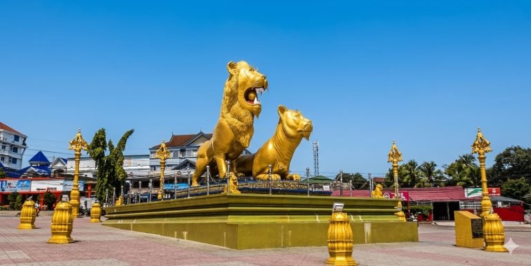 Golden Lion Monument in Sihanoukville Cambodia with large gold lion statues in a central roundabout