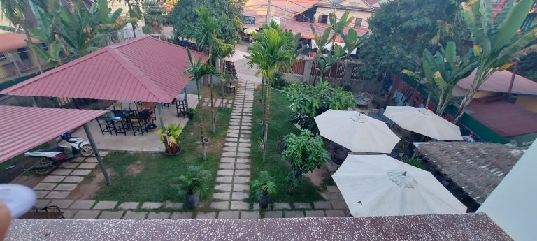 cambodia travel tips guesthouse courtyard with garden and outdoor seating area
