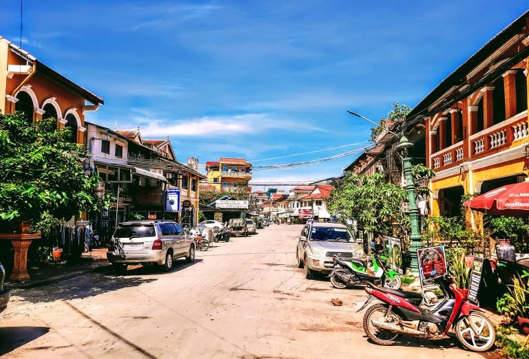 Things to do in Kampot - Quiet street with colonial buildings local shops and motorbikes