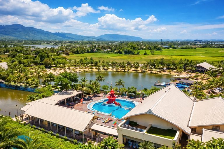 Things to do in Kampot - Komsan Kampot Resort aerial view with pool lagoon and tropical landscape