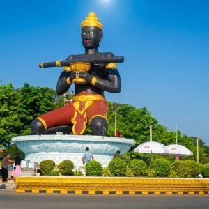Lok Ta Dambong statue in Battambang Cambodia under bright blue skies on a sunny day