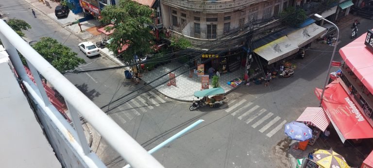 Phnom Penh itinerary street 136 and street 5 intersection with tuk tuk and local shops Caption Description
