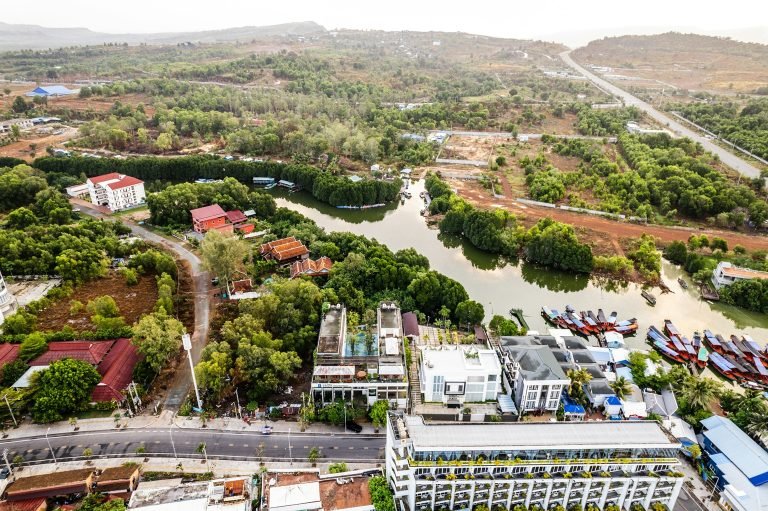 Sihanoukville Cambodia Otres River area with boats, greenery, and riverside buildings