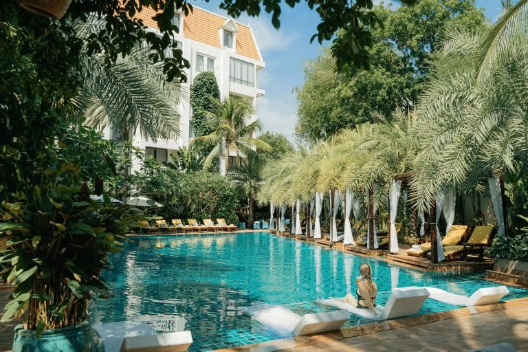 Phnom Penh itinerary Palace Gate Resort swimming pool with tropical garden setting Caption Description