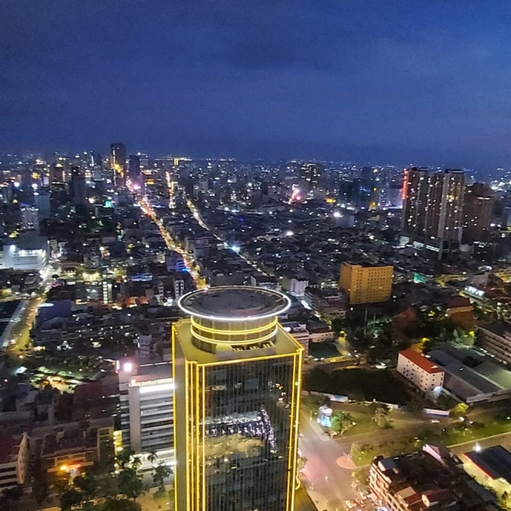Phnom Penh itinerary skyline view at night with city lights and modern buildings