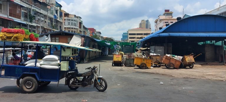Phnom Penh itinerary street scene with tuk tuk and local neighborhood buildings