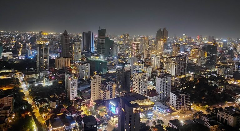 Phnom Penh itinerary skyline at night with illuminated buildings and city lights