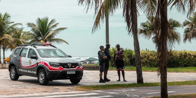 Is Brazil safe – police officers speaking to a man near a beachside road in Brazil