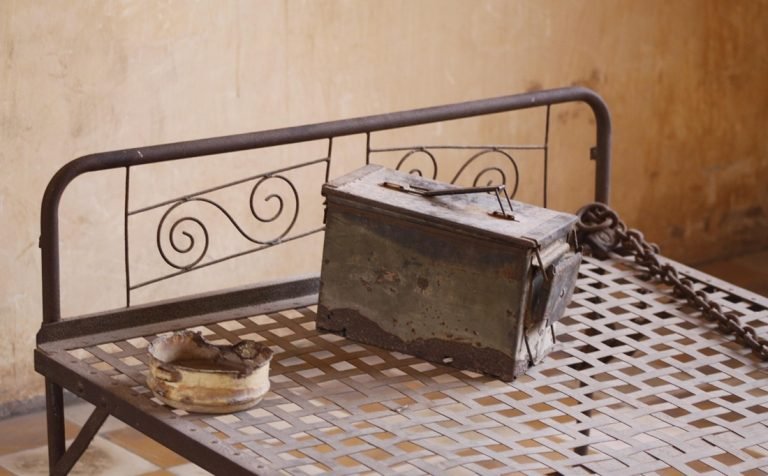 metal bed restraints and container at tuol sleng s21 genocide museum phnom penh