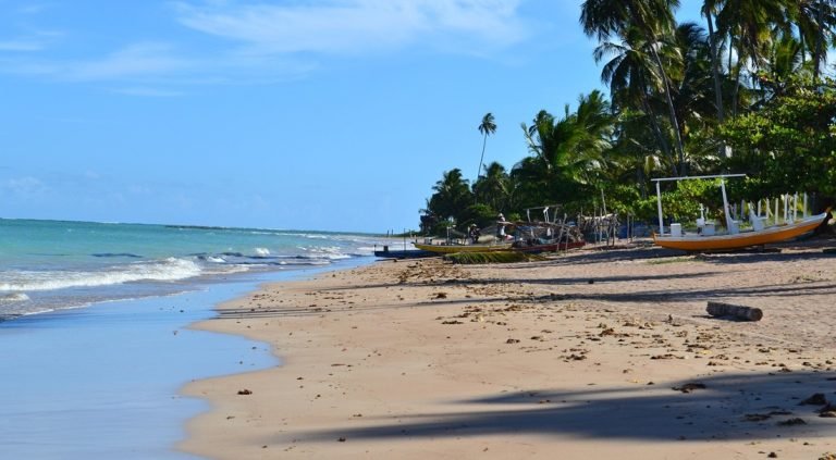 Brazil travel cost - Quiet beach palm trees coastal village budget destination