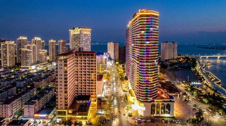 Sihanoukville Cambodia skyline at night with illuminated high-rise buildings and coastal boulevard